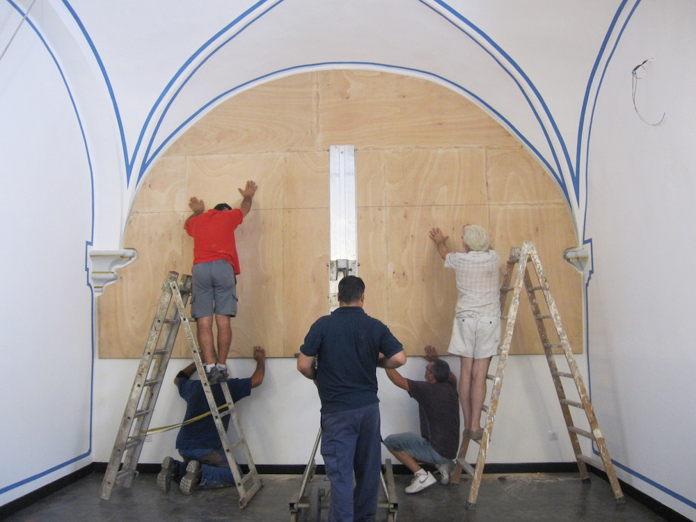 Once in the chapel, the canvas is installed over the frame